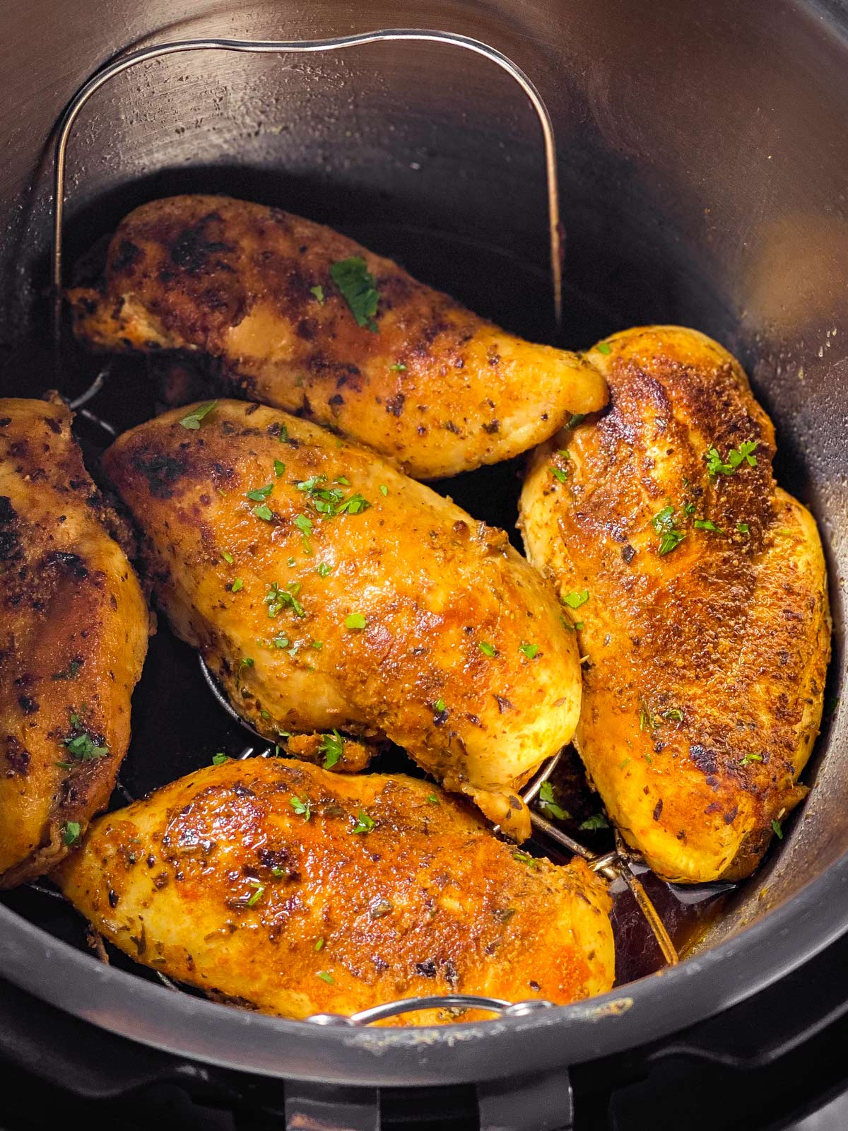 frontal view of five chicken breasts in instant pot