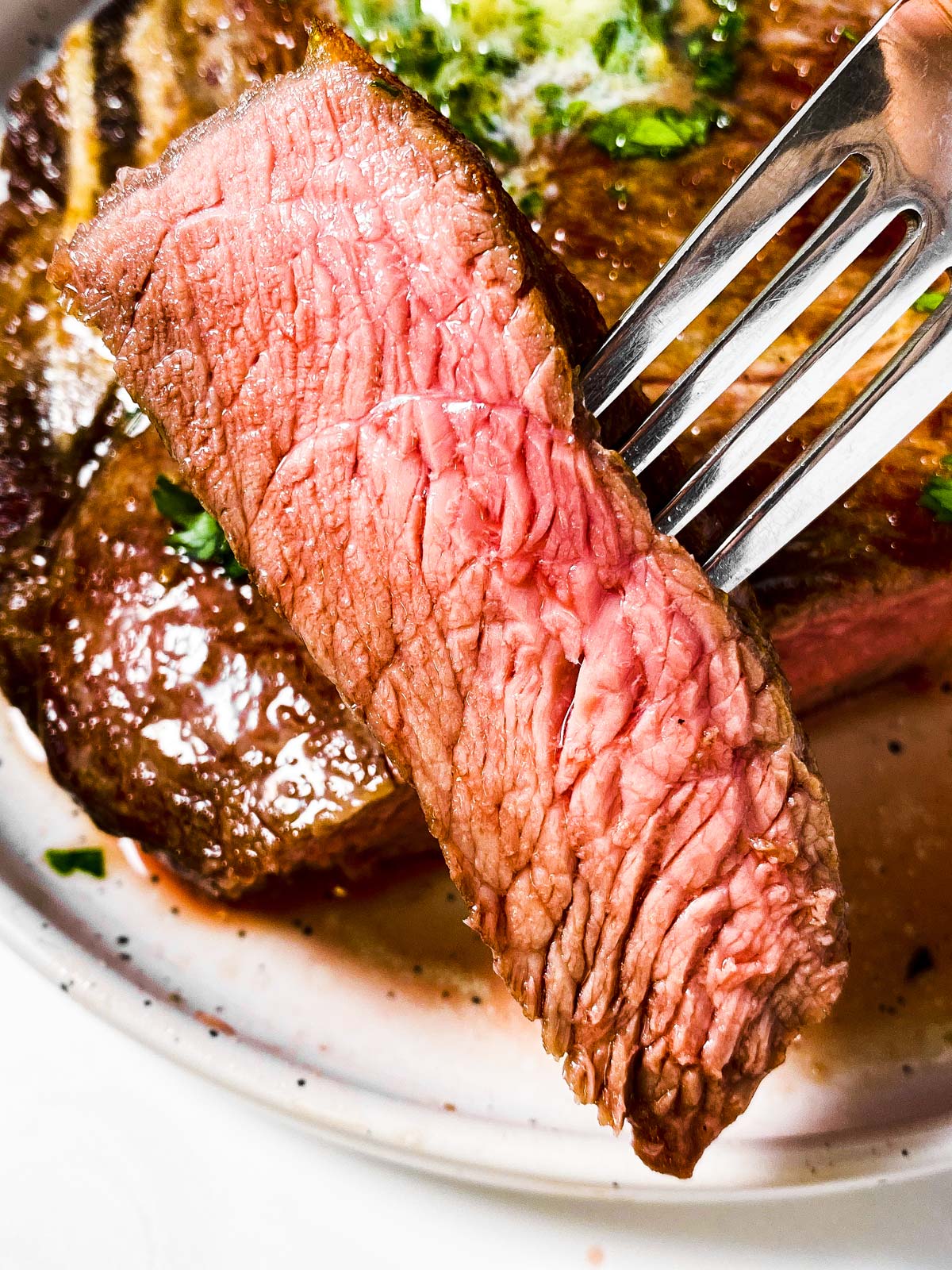 slice of steak speared on fork