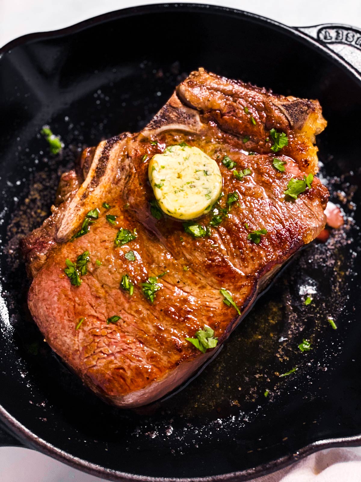 frontal view of steak in black cast iron skillet