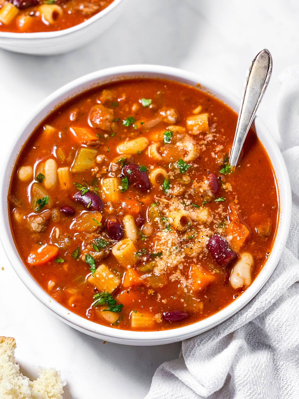 frontal view of white bowl filled with pasta fagioli soup