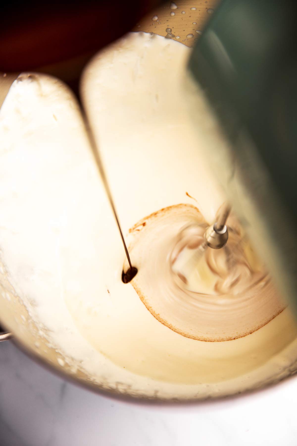 melted chocolate drizzling into whipping cream