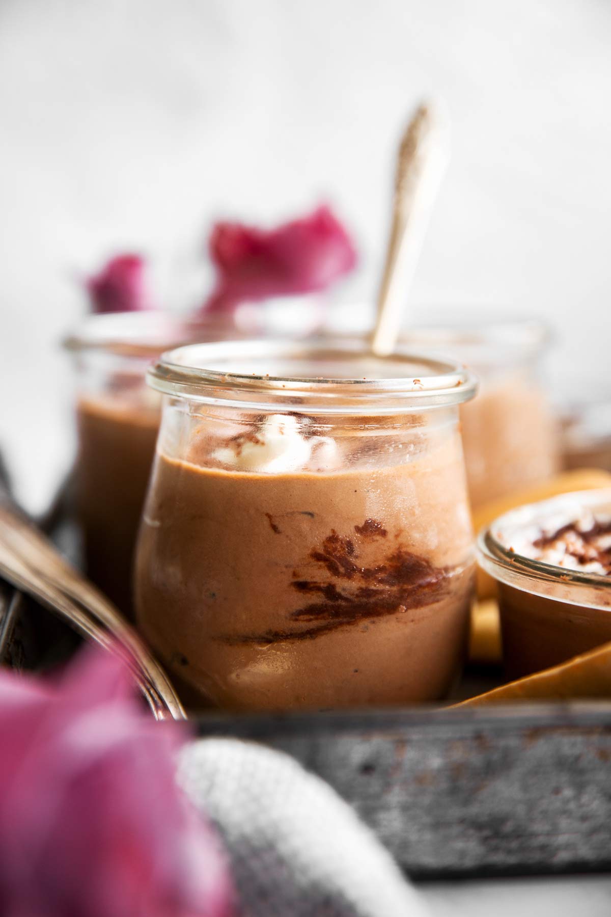 frontal view of tiramisu chocolate mousse in small glass jar