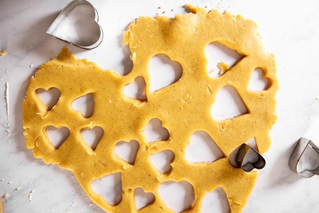 rolled out cookie dough with hearts cut out