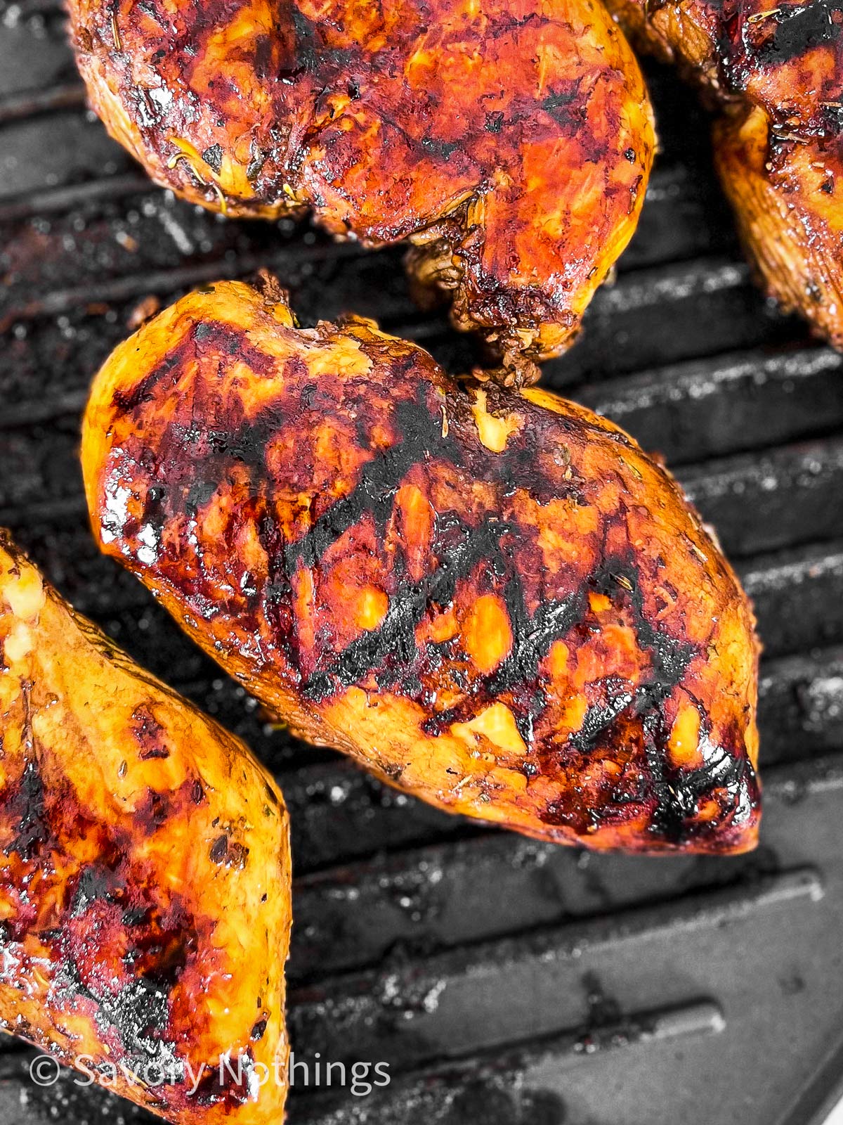 overhead view of balsamic marinated chicken breast on grill