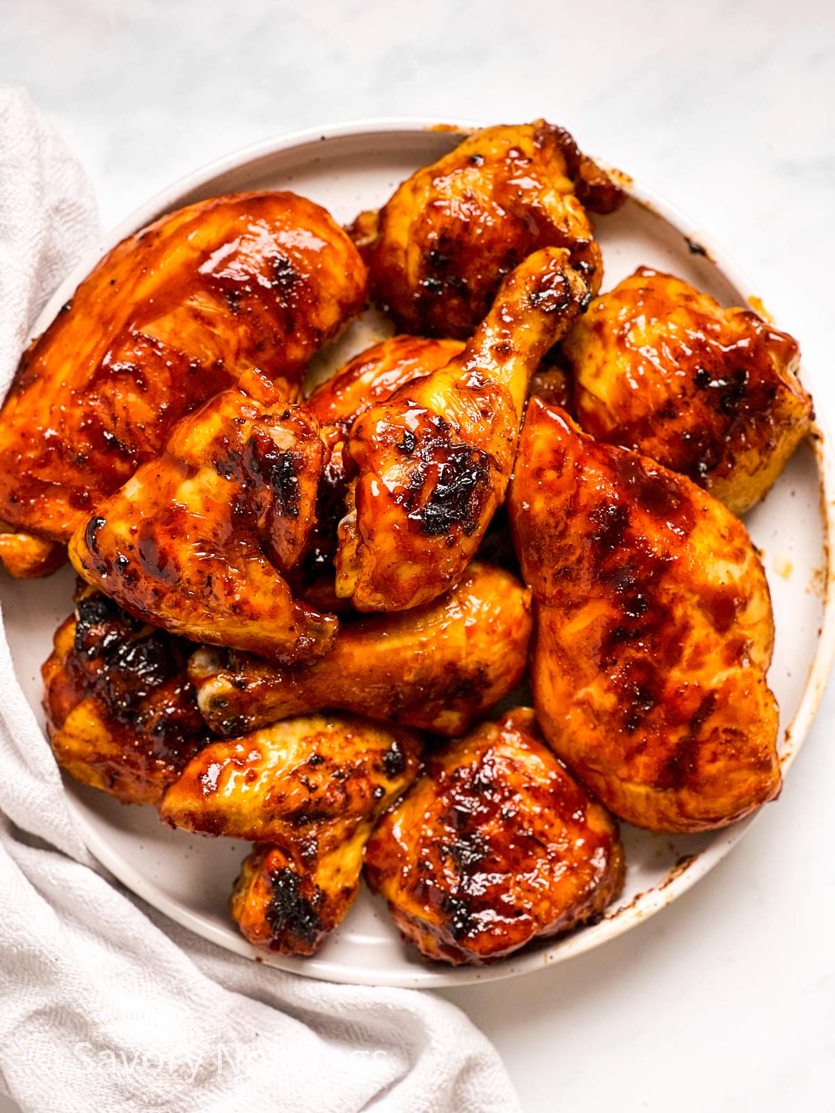 overhead view of BBQ chicken on white plate