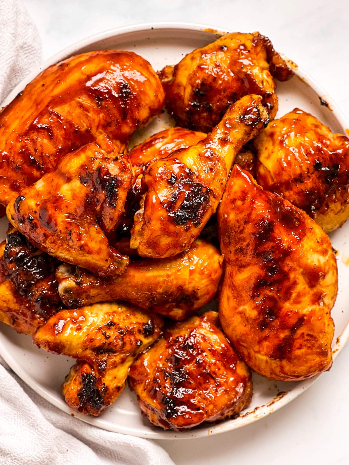 overhead view of BBQ chicken on white plate