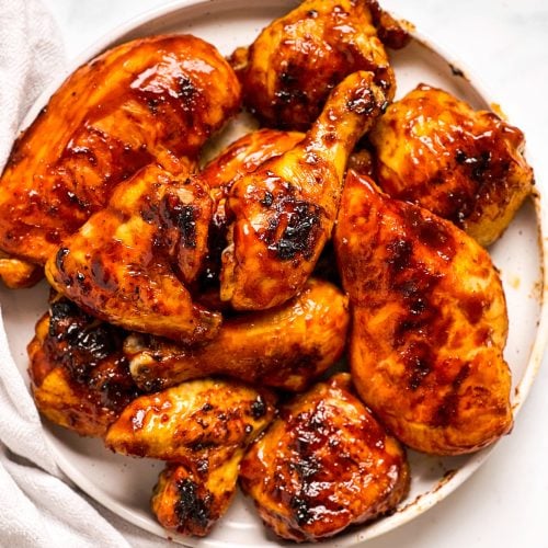 overhead view of BBQ chicken on white plate