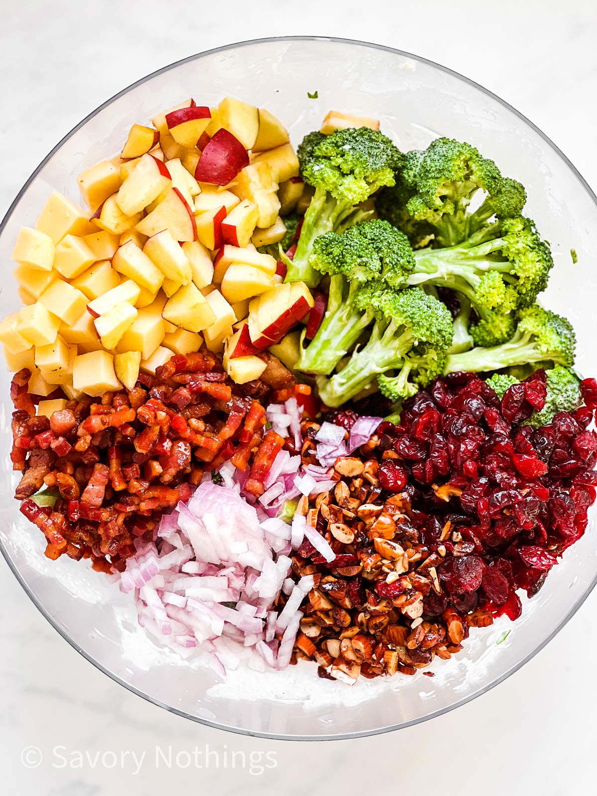 ingredients for broccoli salad in glass bowl