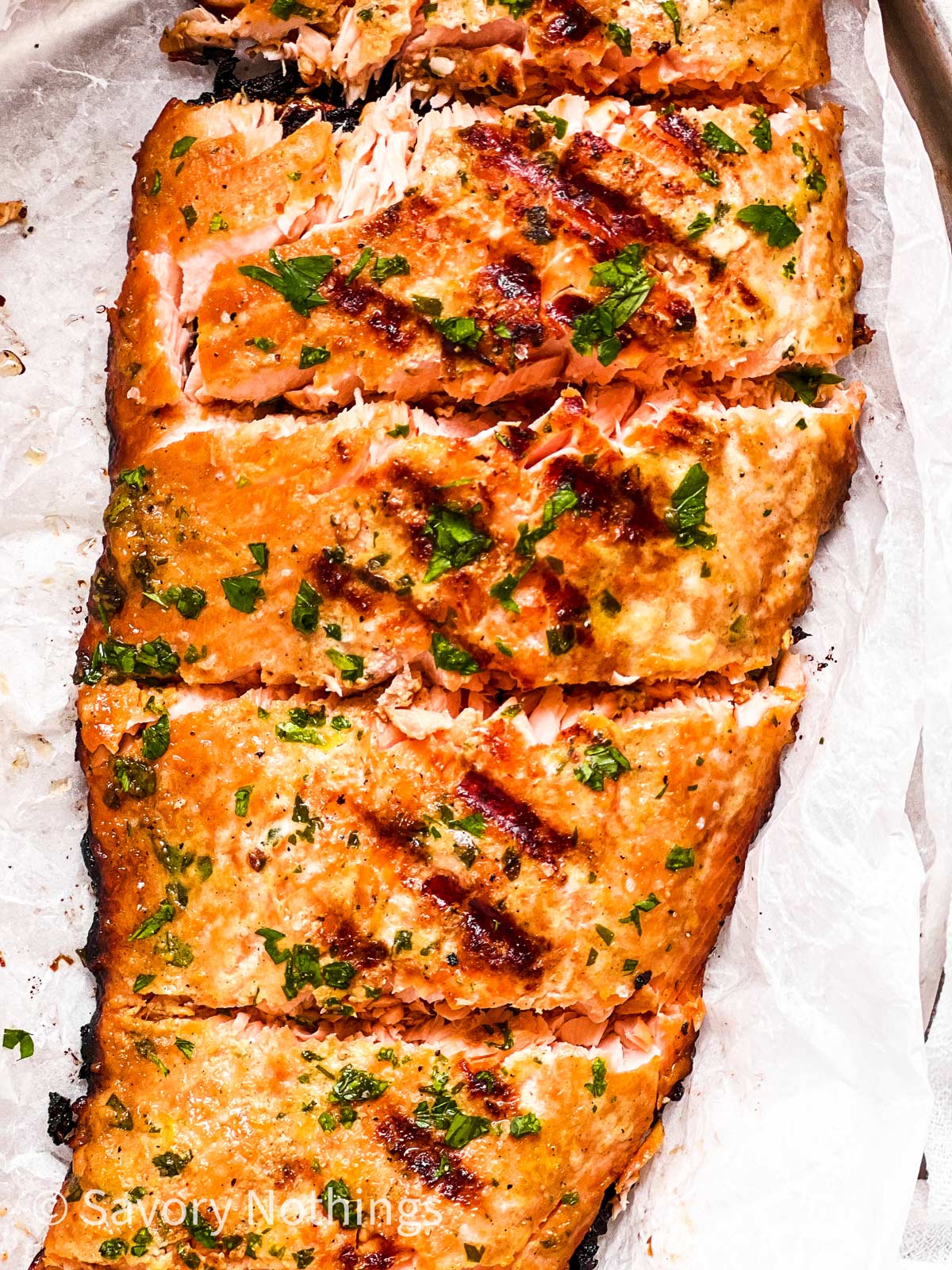 overhead close up of marinated, grilled and sliced salmon fillet