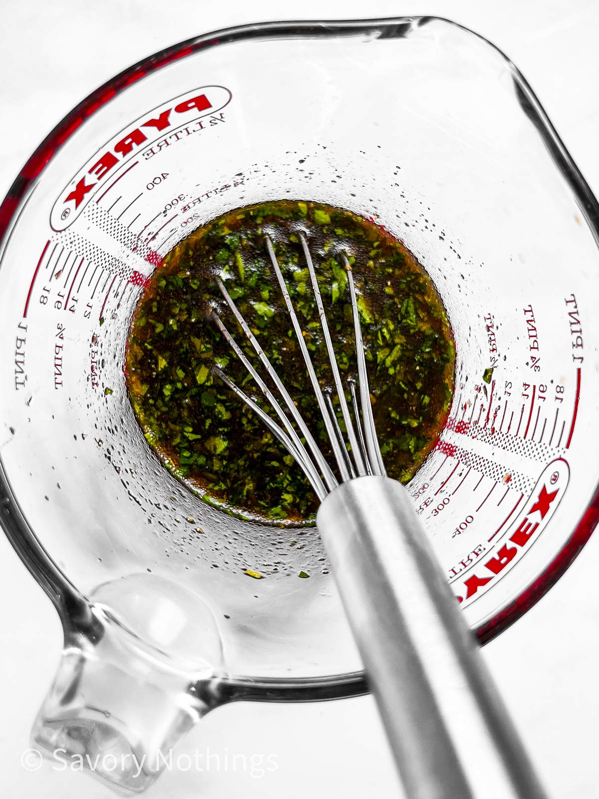 overhead view of salmon marinade in glass measuring jug