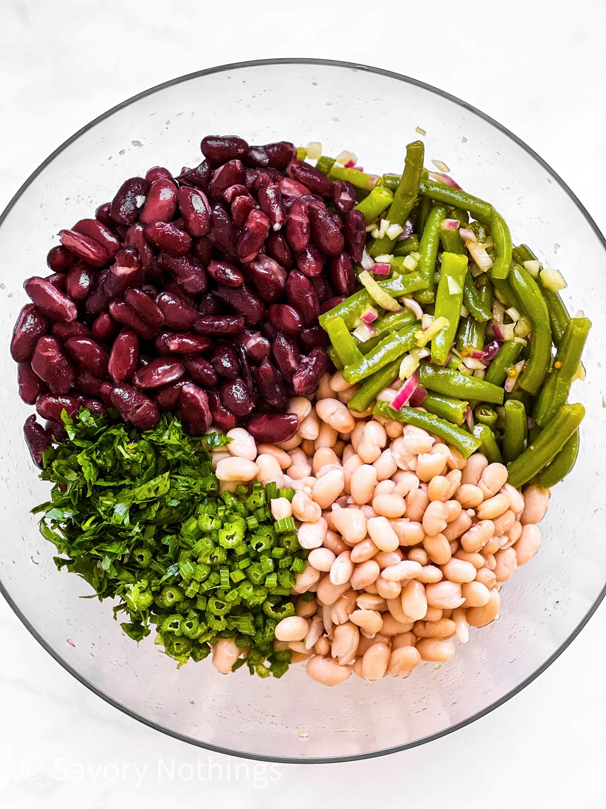 ingredients for three bean salad in glass bowl