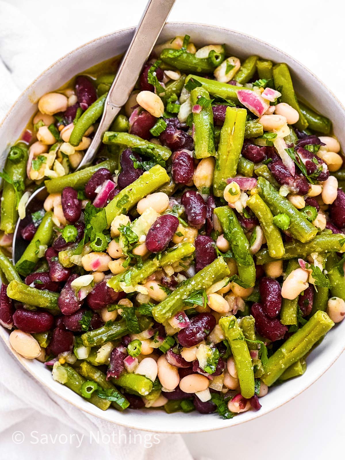 overhead view of three bean salad in white salad bowl