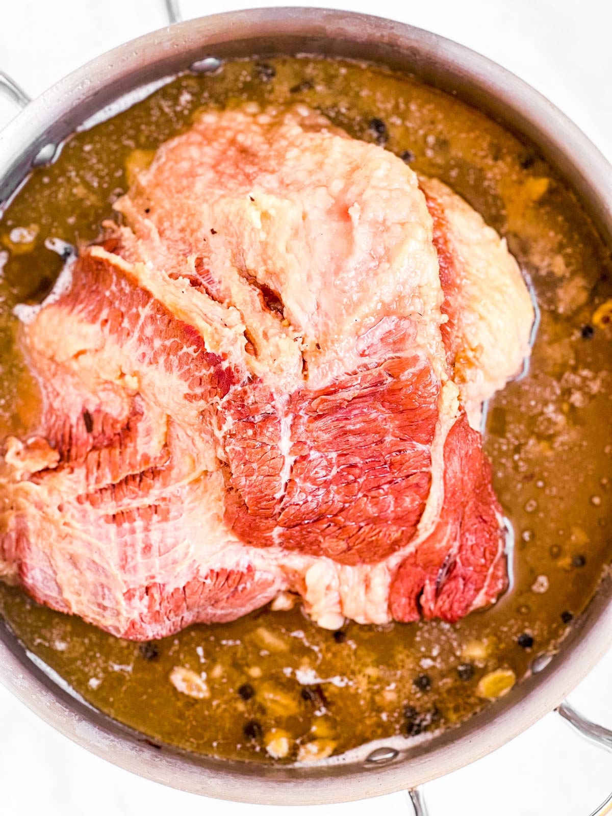 overhead view of cooked corned beef brisket in pot