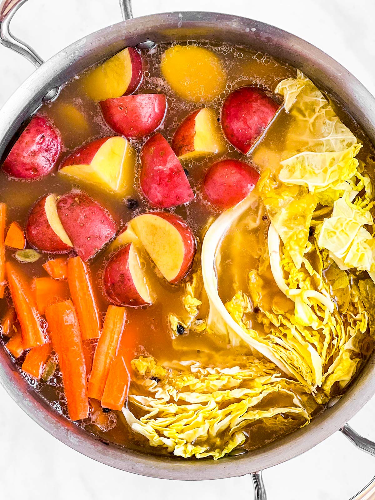 overhead view of vegetables in cooking liquid