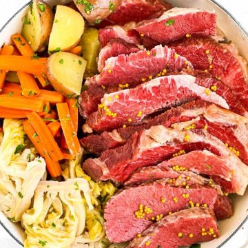 overhead view of sliced corned beef and vegetables in white round pot