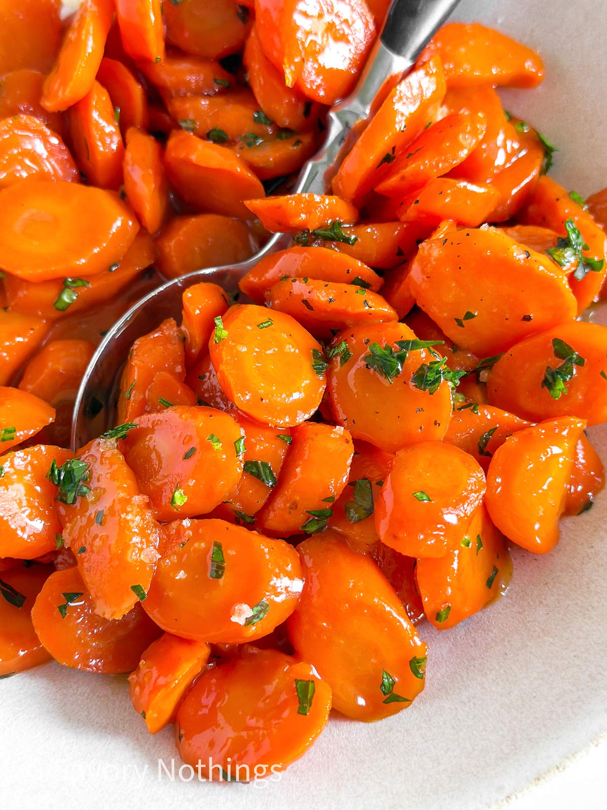 close up photo of glazed carrots with parsley
