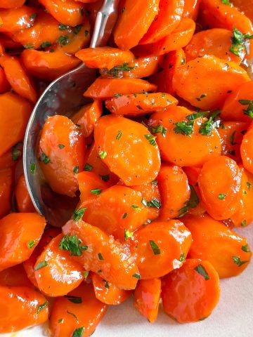 close up photo of glazed carrots with parsley