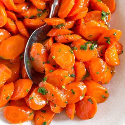 close up photo of glazed carrots with parsley