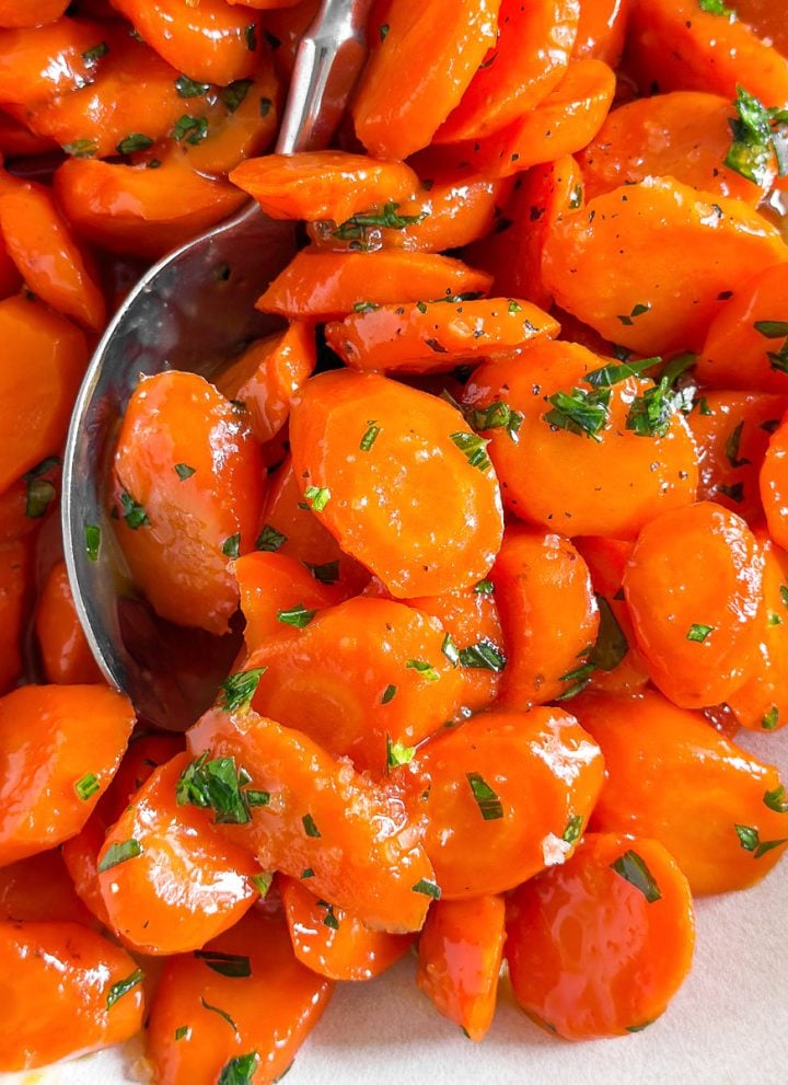 close up photo of glazed carrots with parsley