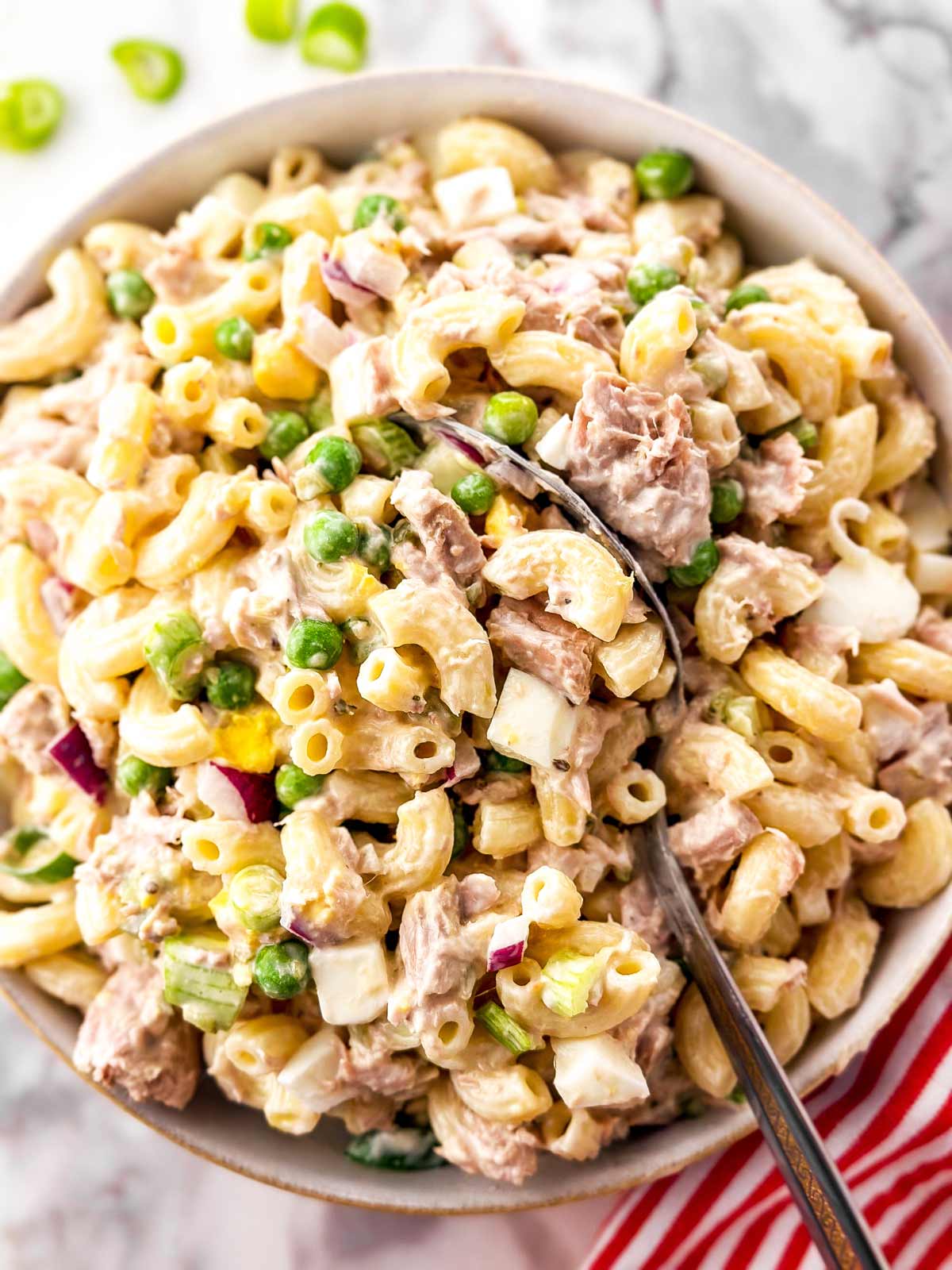 overhead view of tuna macaroni salad in white bowl