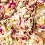 overhead close up view of wooden spoon filled with coleslaw