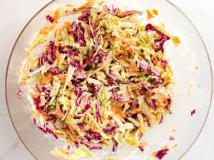 overhead view of uncoiled coleslaw in glass bowl