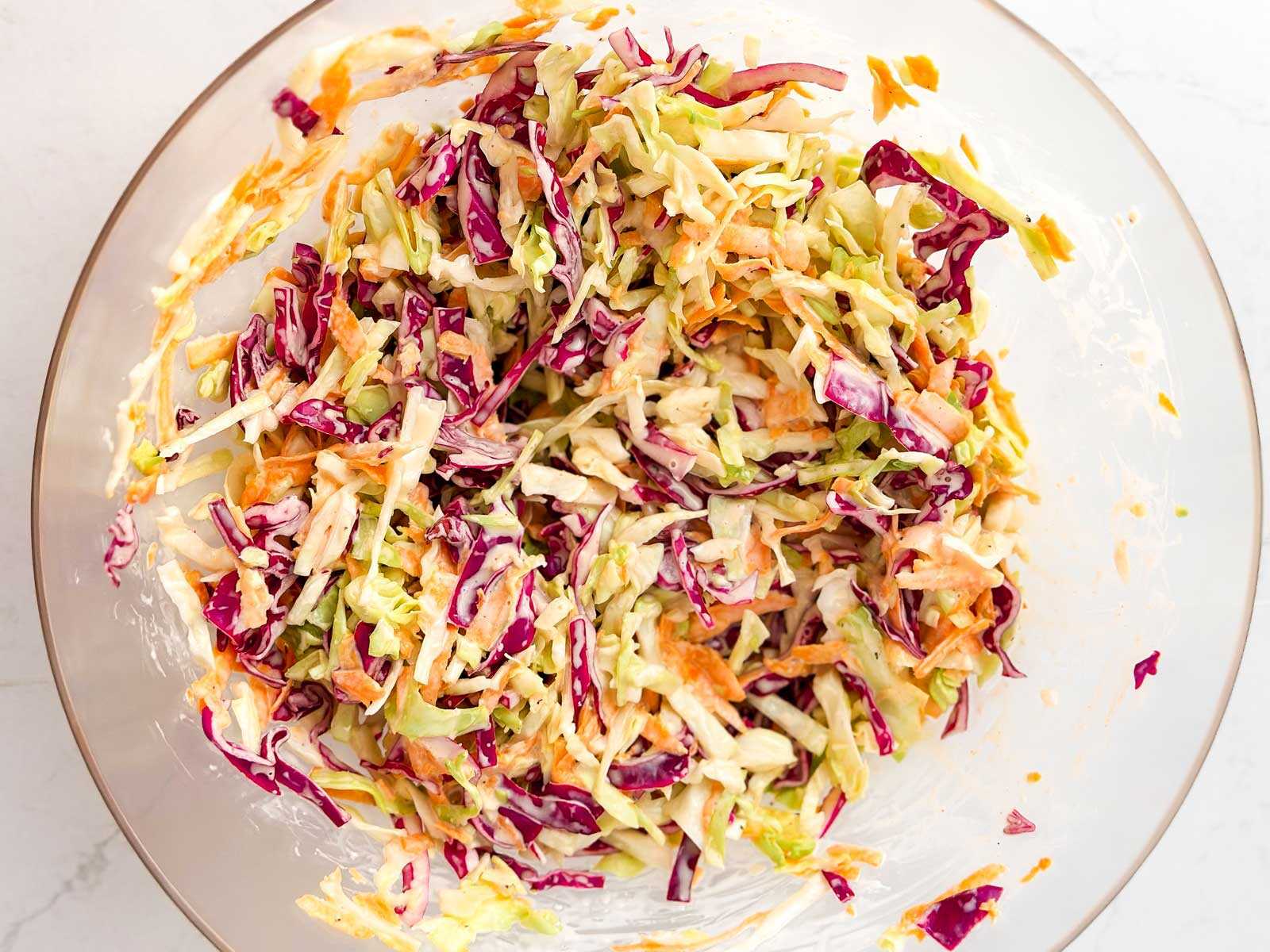overhead view of uncoiled coleslaw in glass bowl