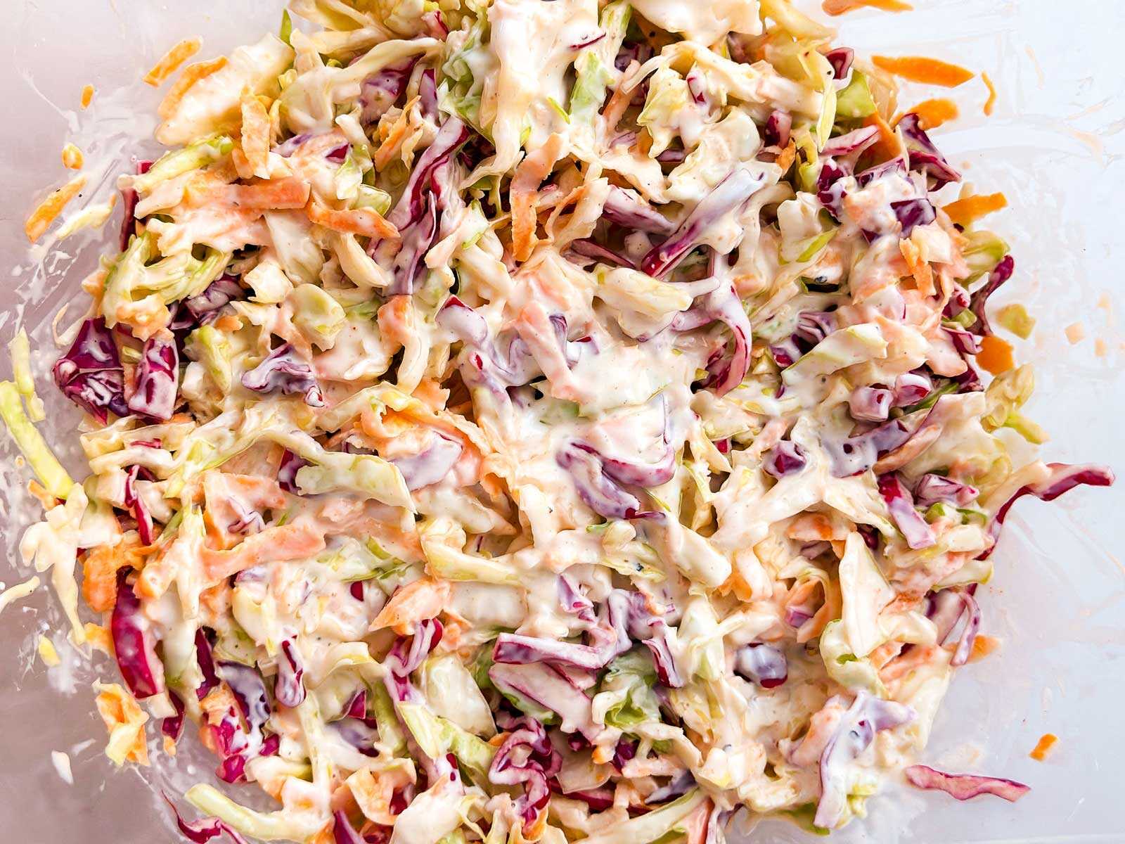 overhead view of chilled coleslaw in glass bowl