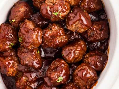 overhead close up view of bbq meatballs in white crock of slow cooker