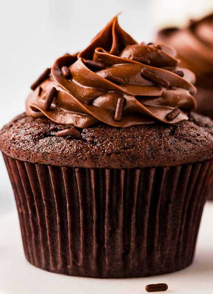 frontal view of chocolate cupcake topped with whipped ganache frosting