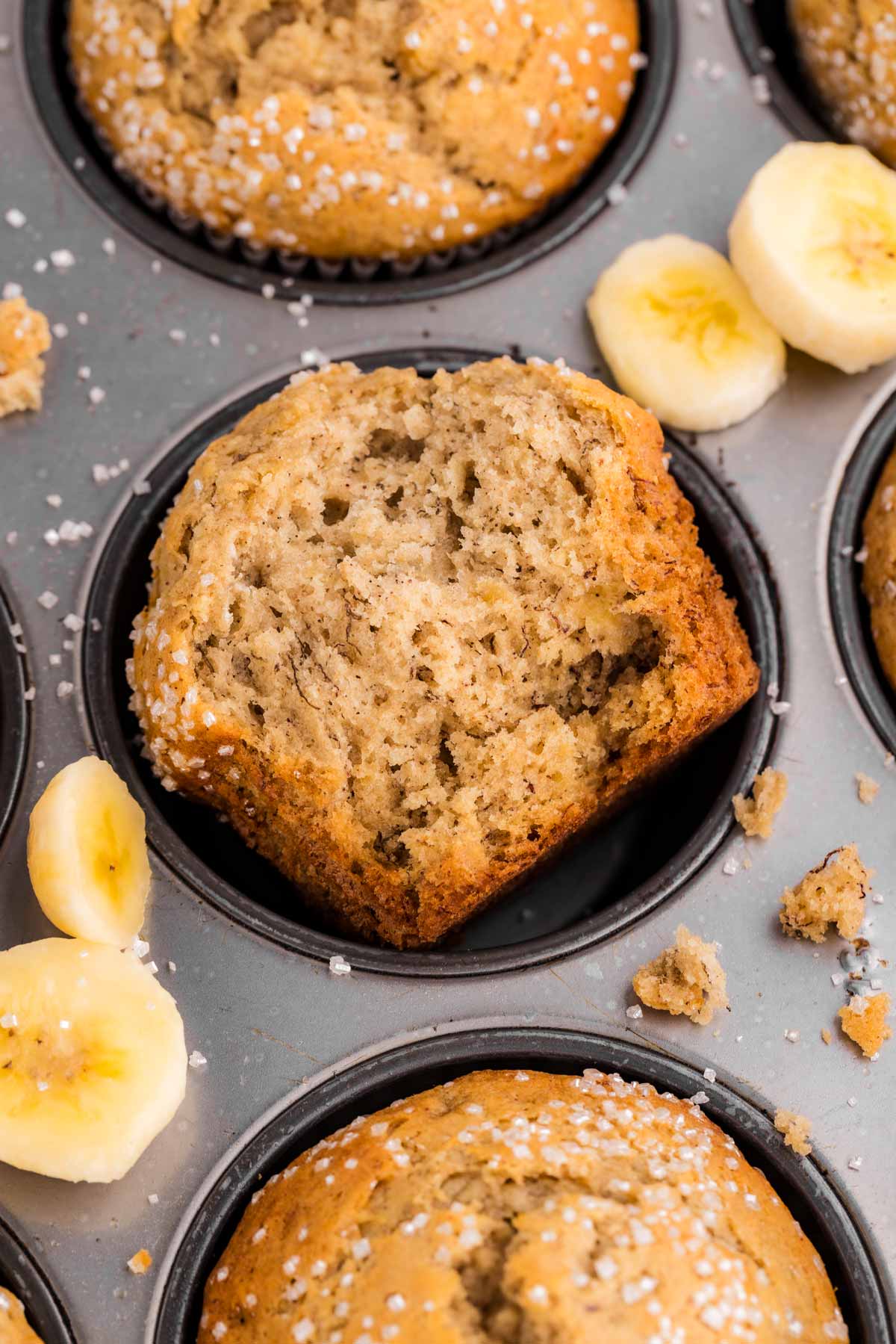 overhead view of halved banana muffin in muffin pan