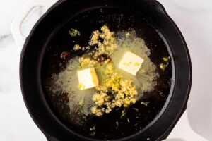 overhead view of lemon zest and butter in skillet