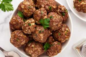 overhead view of baked meatballs in round bowl
