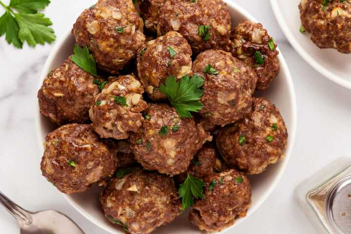 overhead view of baked meatballs in round bowl
