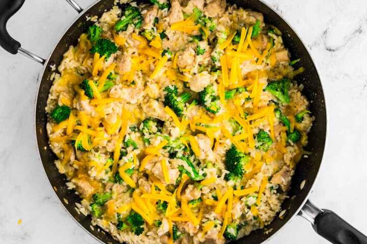 overhead view of chicken broccoli rice and cheese in skillet