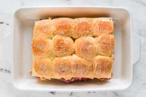 overhead view of dinner rolls brushed with melted butter in casserole dish