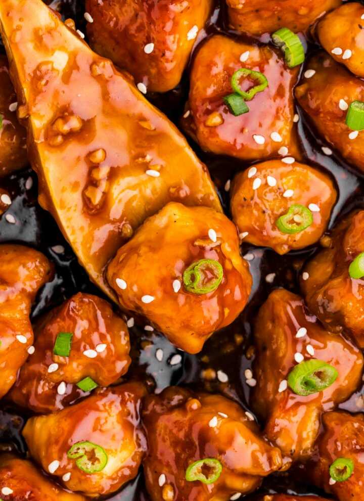 overhead view of wooden spoon in teriyaki chicken