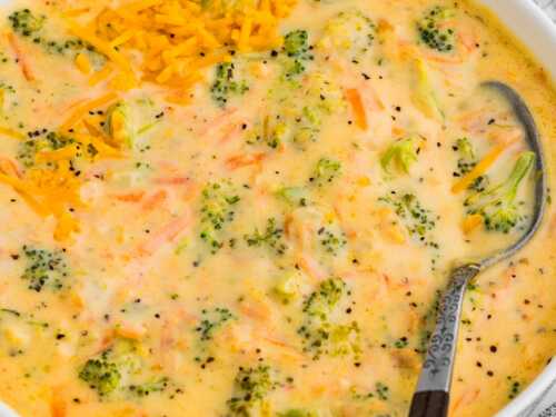 Bowl of creamy broccoli cheddar soup with shredded cheese on top
