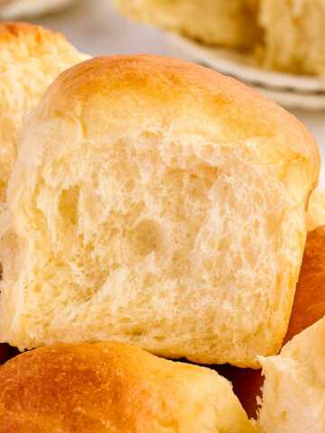 frontal view of potato dinner rolls stacked on top of each other