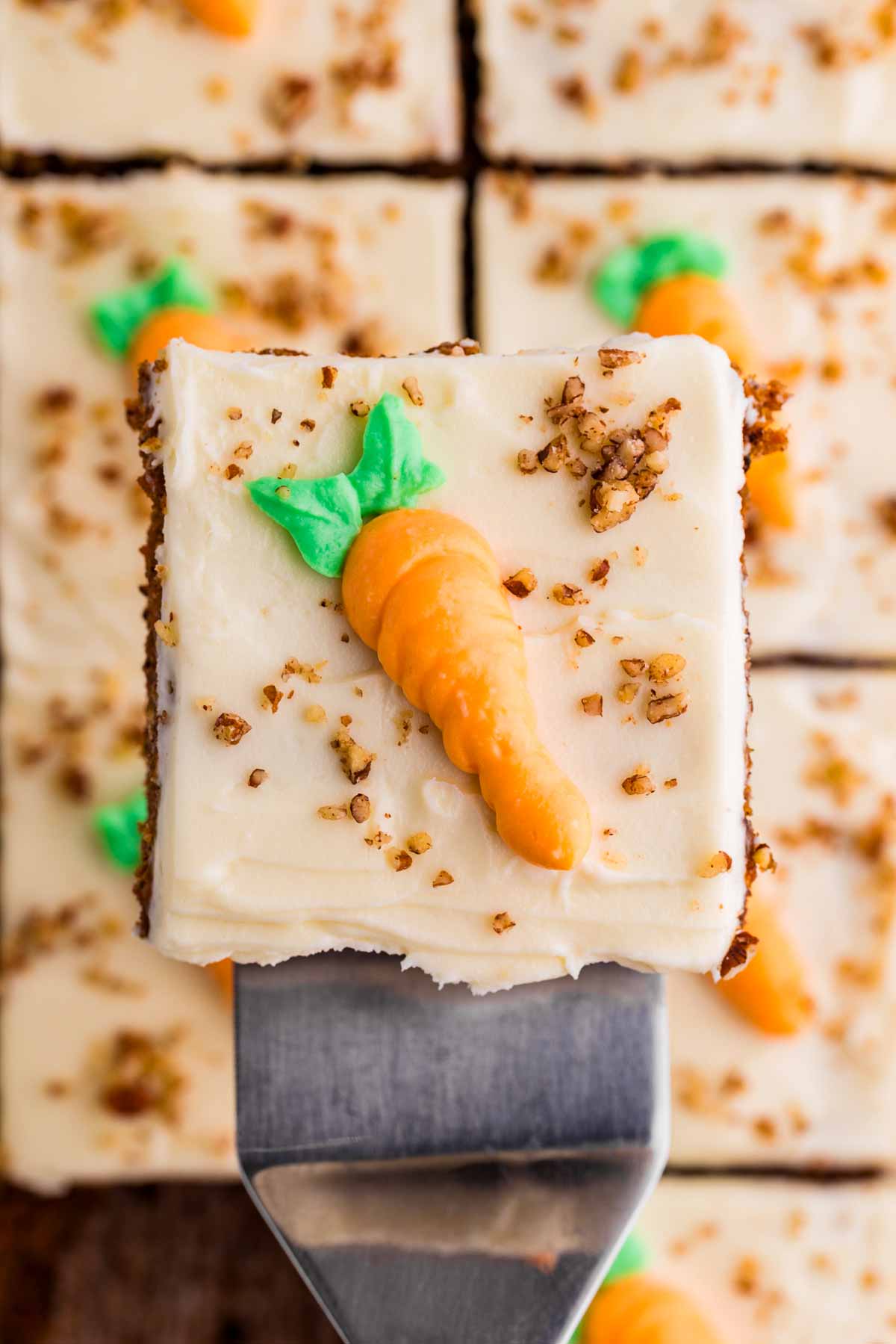 overhead view of carrot sheet cake slice on cake spatula