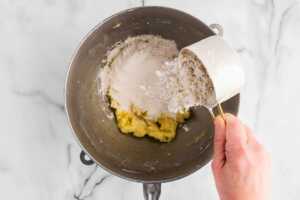 adding dry ingredients to creamed ingredients for Easter sugar cookies