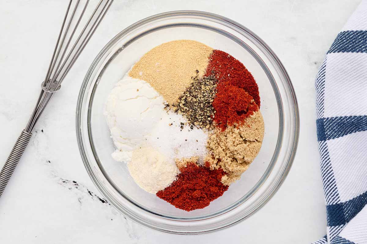 overhead view of glass bowl filled with seasoning to rub on salmon