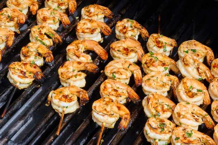 shrimp skewers being grilled