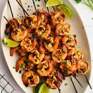 grilled shrimp skewers on platter