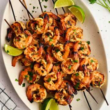 grilled shrimp skewers on platter