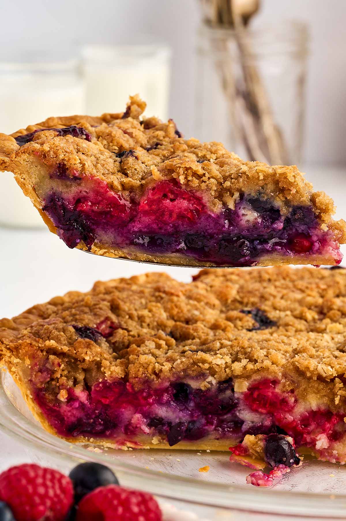 slice of berry custard pie being lifted from pan