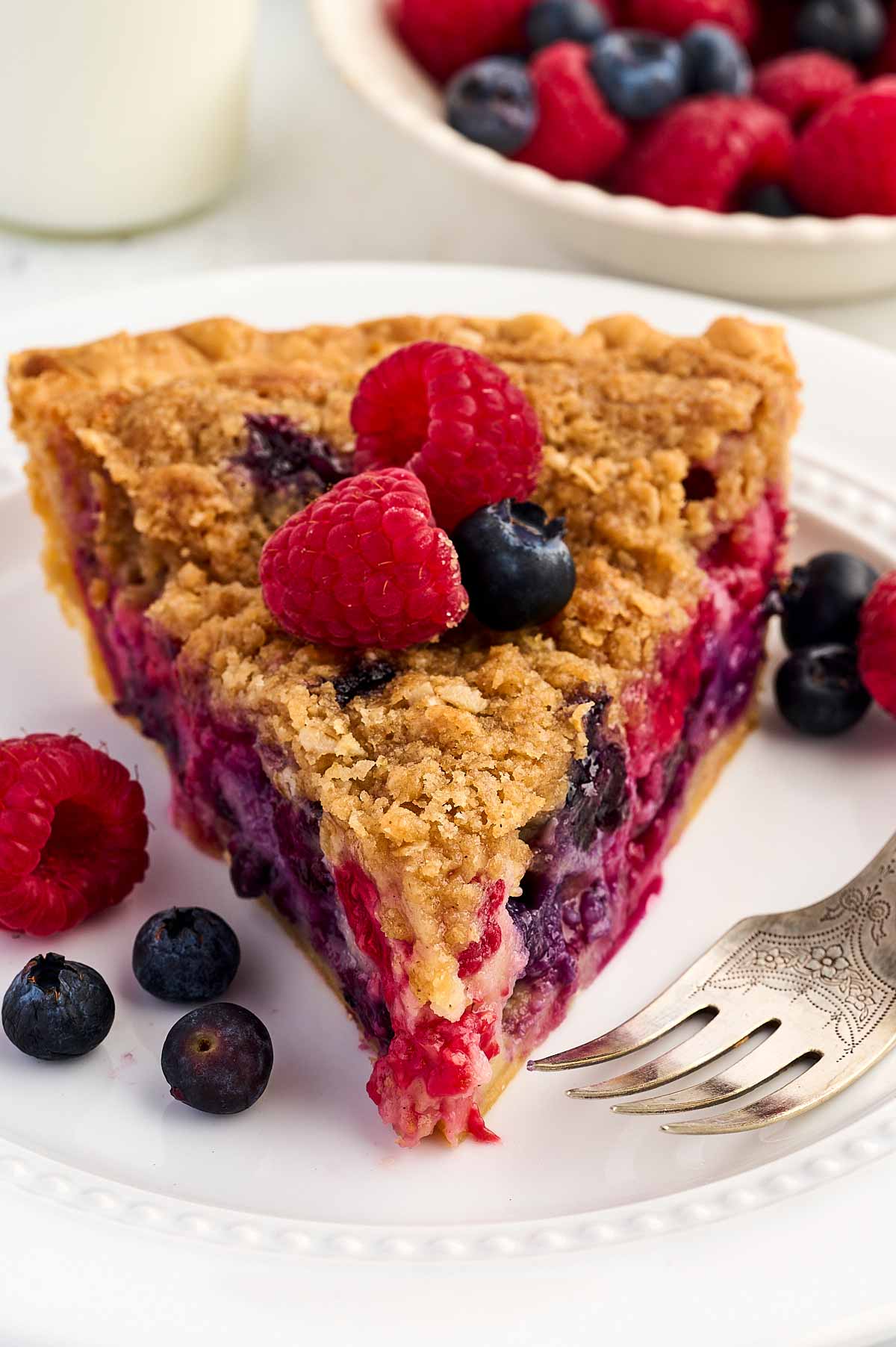 slice of berry custard pie on white plate