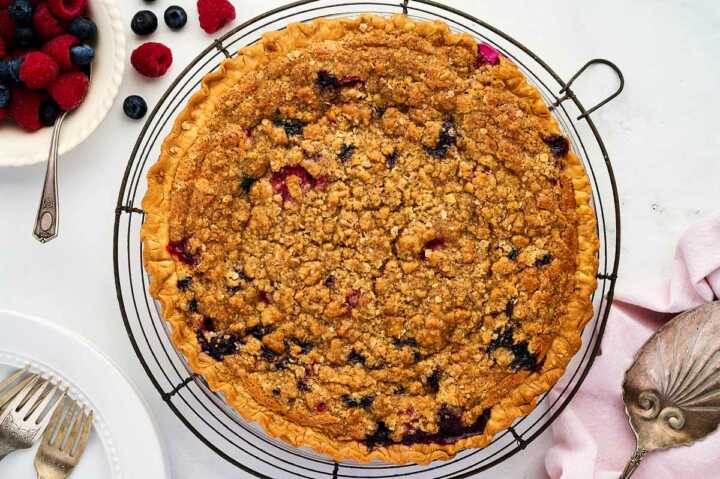 berry custard pie cooling on wire rack