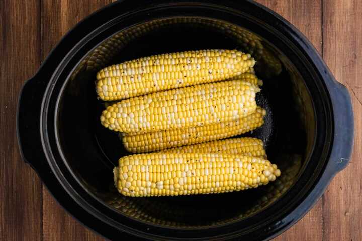 uncooked corn cobs in crock