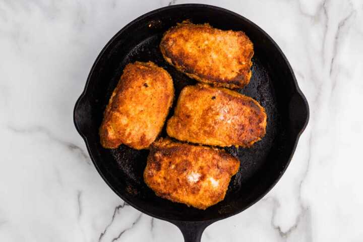 homemade shake and bake pork chops on cast iron pan right after baking